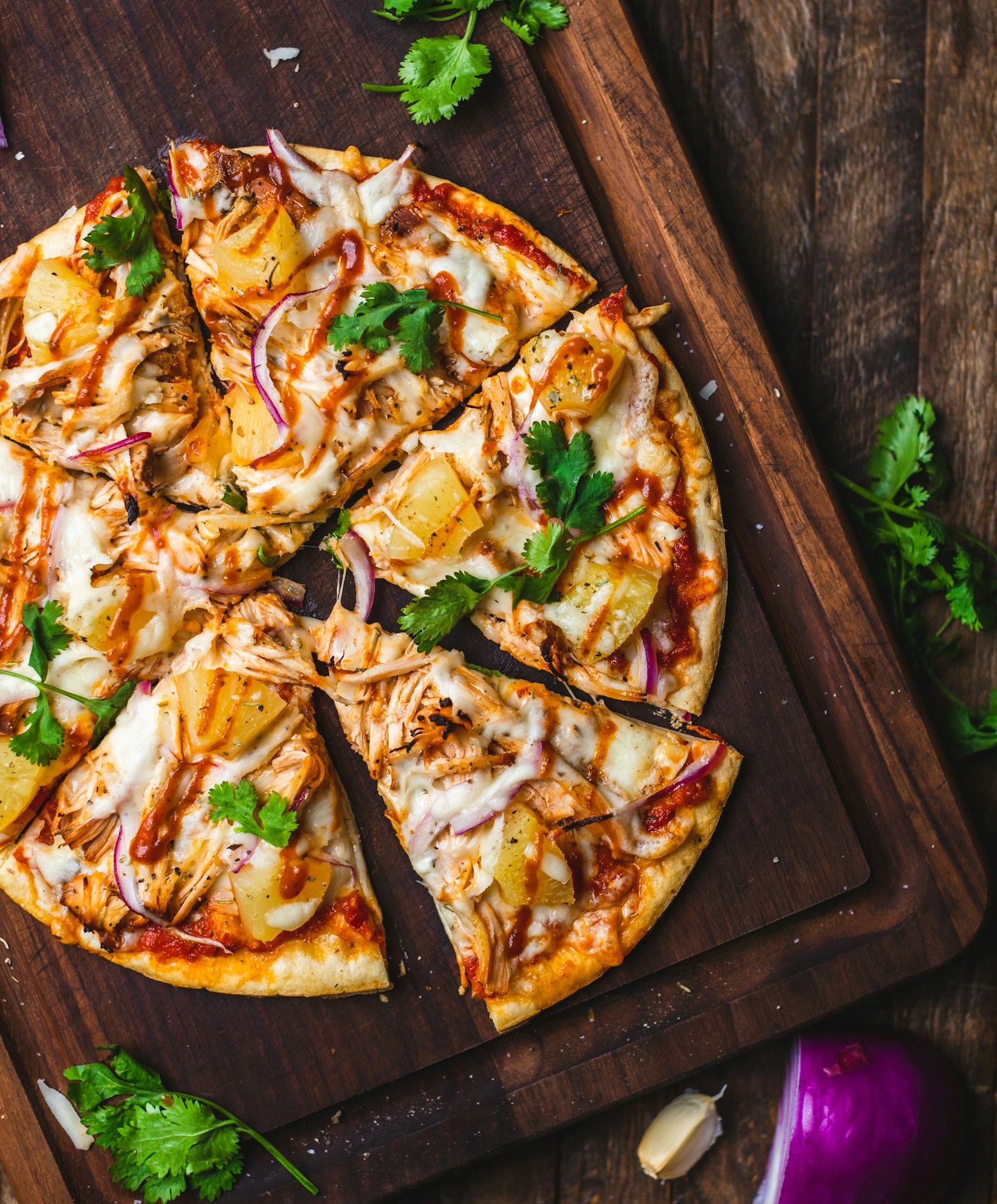 Pizza cut into slices on a wood board
