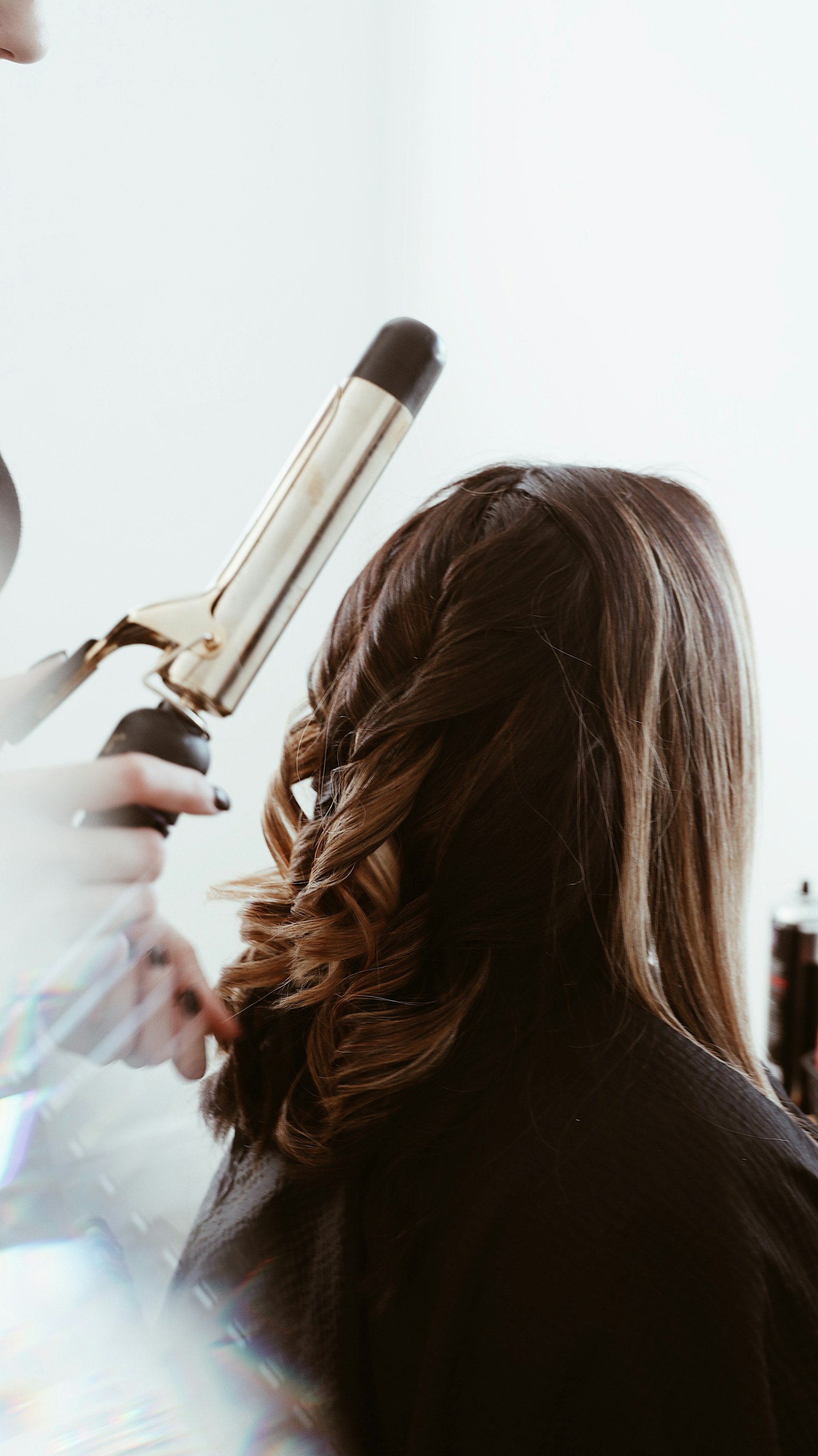 Hair being styled with a curling iron