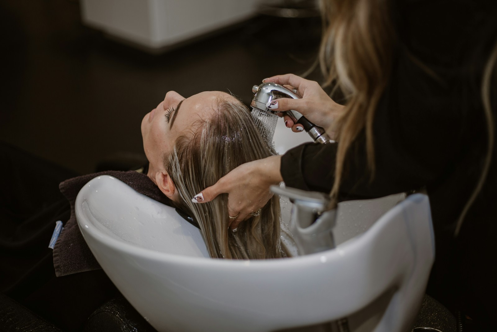 Hair being rinsed in a salon basin