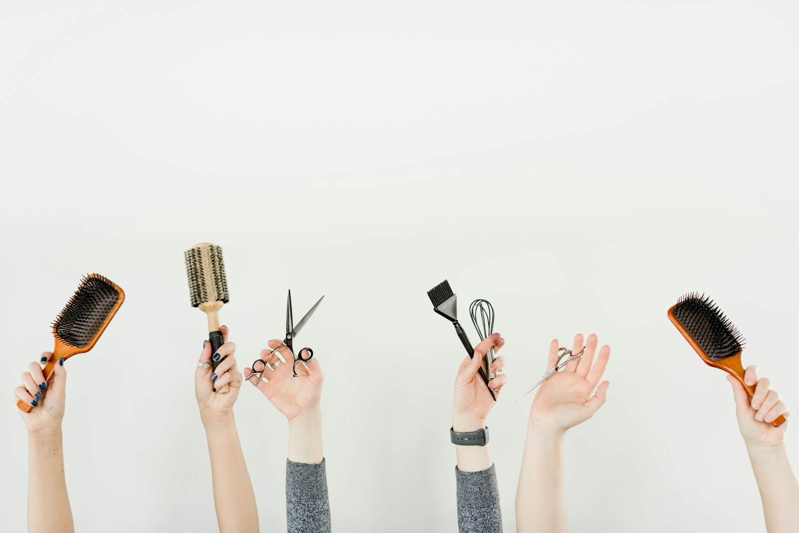 Hands holding hair styling tools